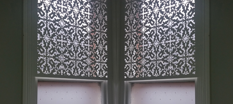 Jali fretwork panels at a window